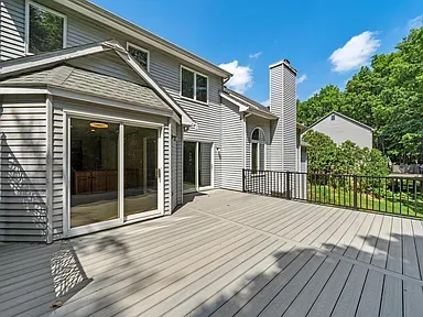 Composite deck surface with picture frame border and black railing system in Ann Arbor backyard