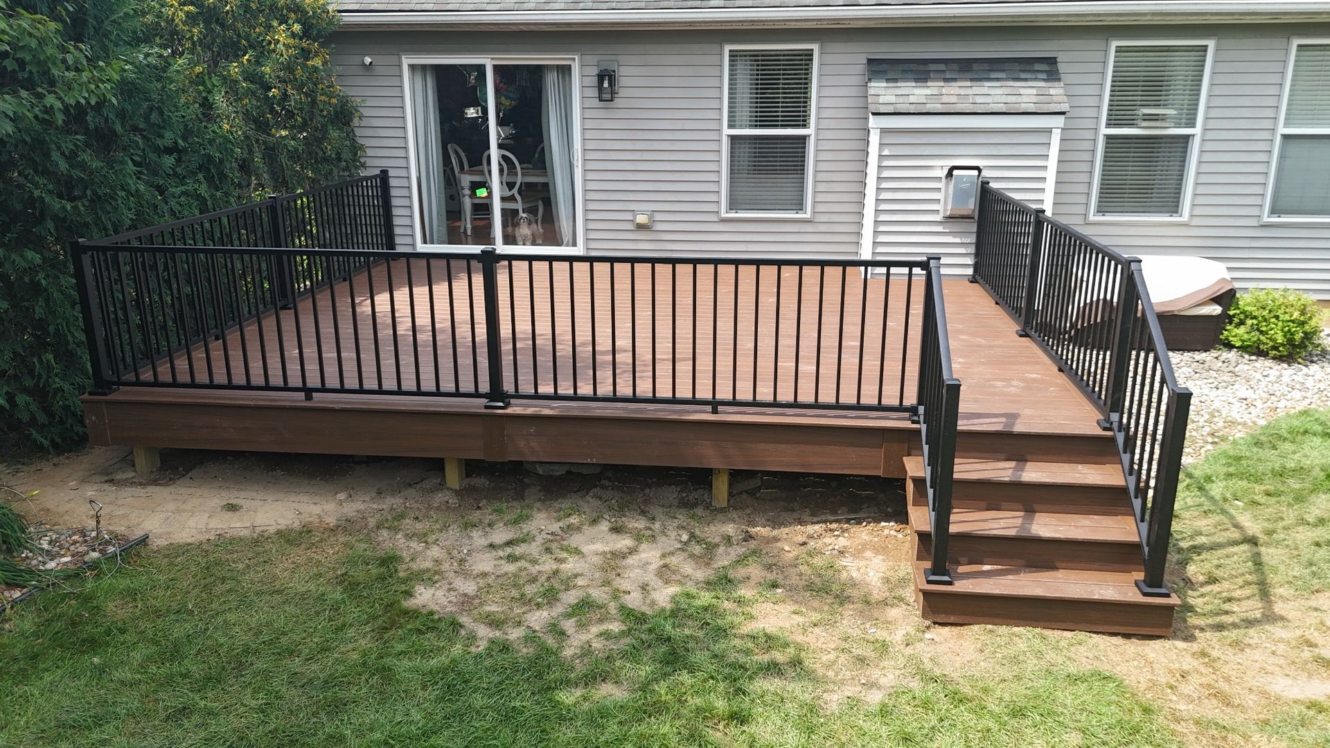 Composite backyard deck with black aluminum railing in Chadwick Farms subdivision Green Oak Township Michigan