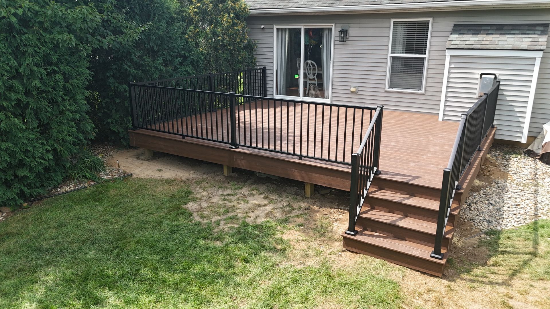 Composite backyard deck with black aluminum railing in Chadwick Farms subdivision Green Oak Township Michigan