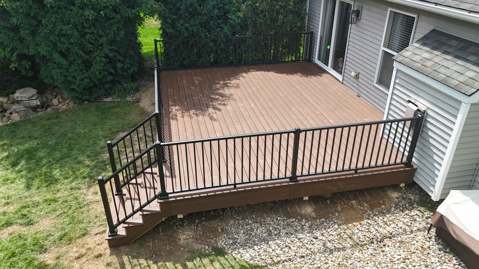 Composite backyard deck with black aluminum railing in Chadwick Farms subdivision Green Oak Township Michigan
