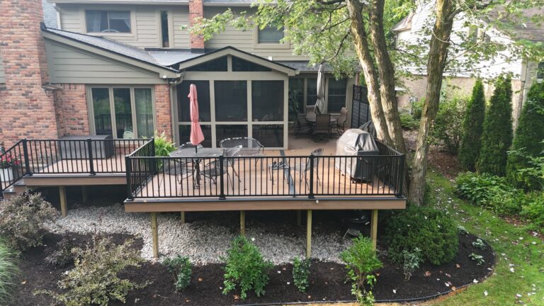 Backyard composite deck with aluminum railing in Abbey Knoll Estates subdivision Northville Michigan