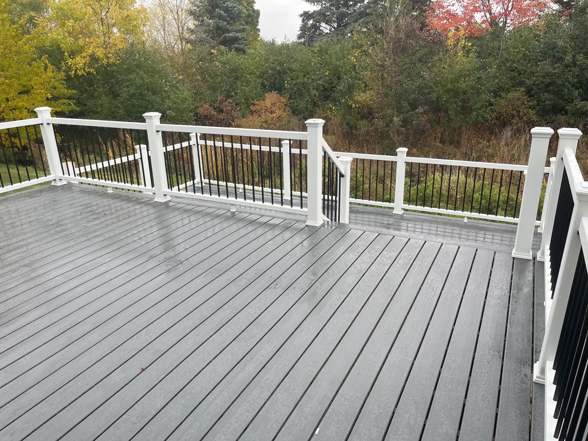 Trex Basics clamshell composite deck stairs with Trex Select white railing in Pickwick Village Canton Township