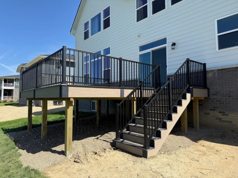 Composite deck with black railing overlooking pond in Windridge Estates Lyon Township Michigan
