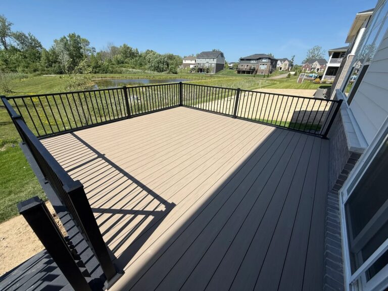 Elevated composite deck with stairs and black aluminum railing in Windridge Estates Lyon Township Michigan
