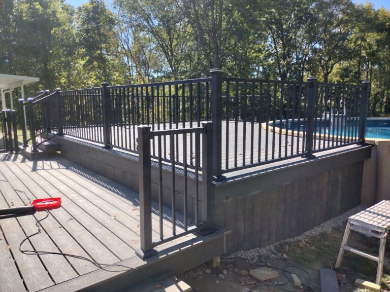 Corner view of composite pool deck and black railing in Salem Township MI