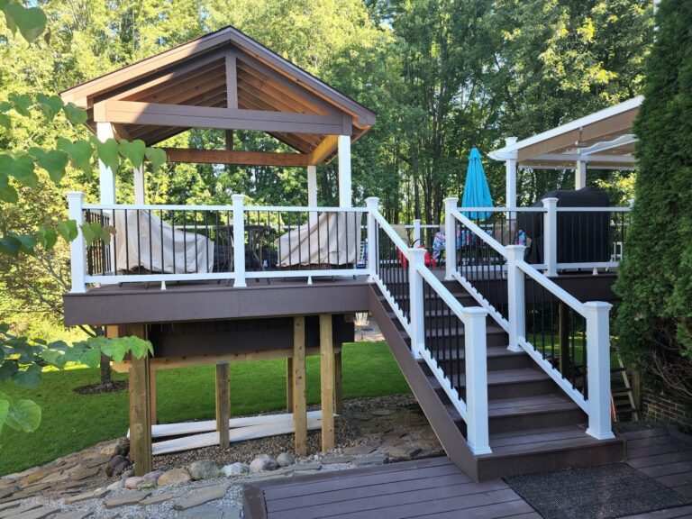 Composite deck stairs with white posts and black balusters in South Lyon Michigan