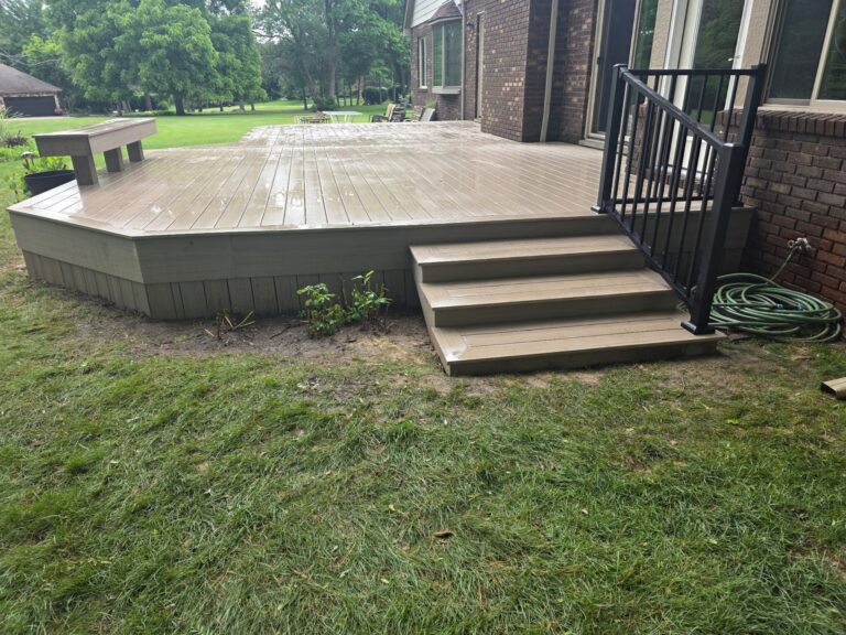 Trex Signature black aluminum railing installed on composite deck stairs in Milford, Michigan