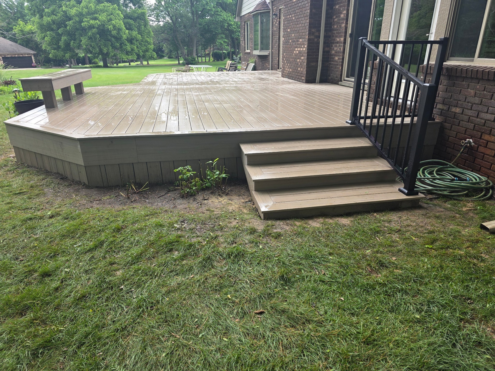 Trex Signature black aluminum railing installed on composite deck stairs in Milford, Michigan