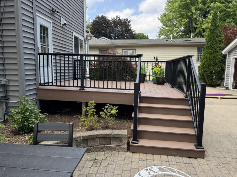 Composite deck renovation completed by Titan Decks in Historic Downtown Northville using Deckorators Summit Cliffside decking and Trex Signature railing.