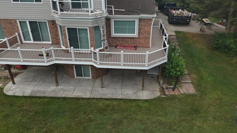 Rear-right aerial view of Deckorators Summit Cliffside decking with white AZEK fascia and Trex Select railing.